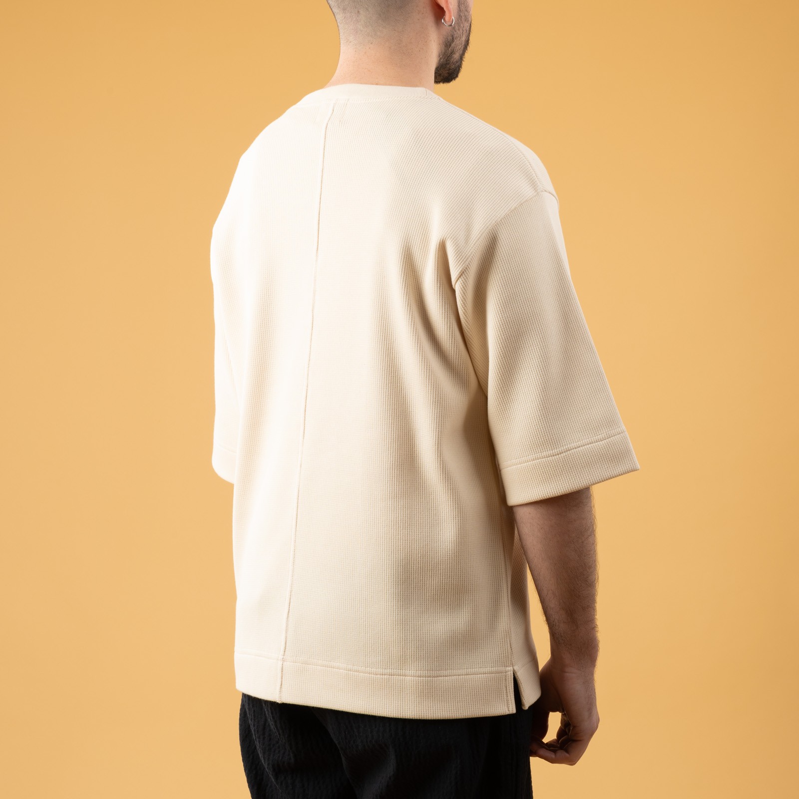 NITTO KNITWEAR Vahe Natural T-Shirt featuring images of leisurely walkers, viewed from the back.