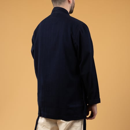 Image of flâneurs UNIVERSAL WORKS Kyoto Work Jacket Indigo Herringbone worn from the back