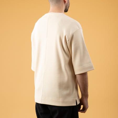 NITTO KNITWEAR Vahe Natural T-Shirt featuring images of leisurely walkers, viewed from the back.