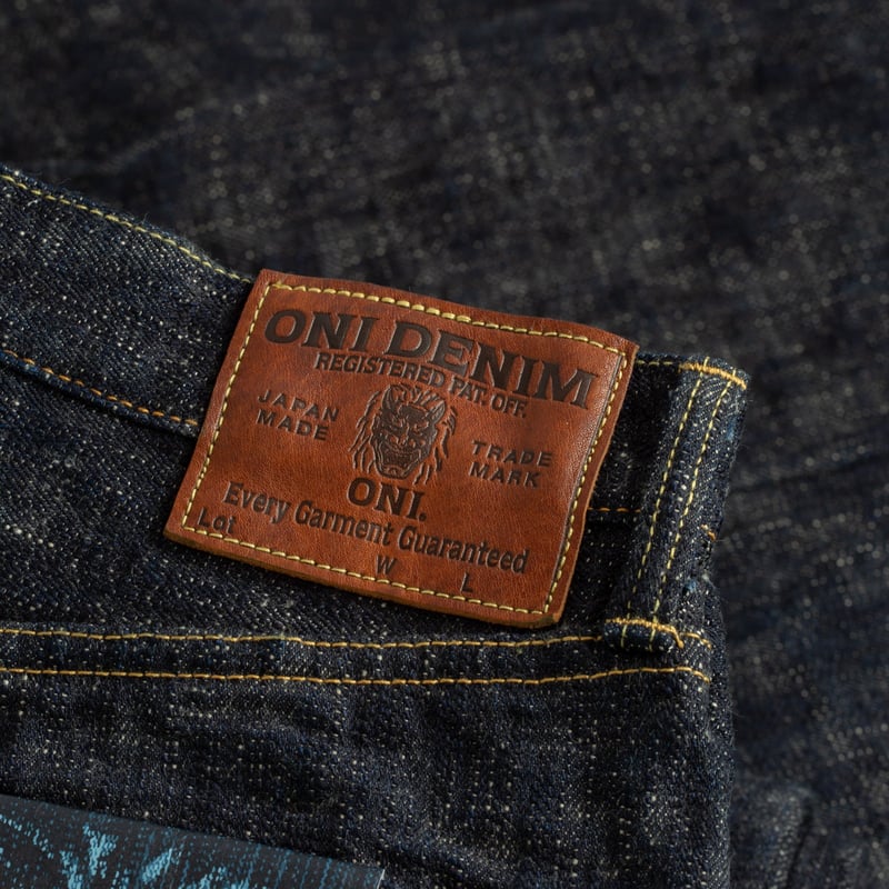 Photo of flâneurs wearing ONI DENIM 288-Kasuri 17oz Regular Straight Denim with a leather patch.