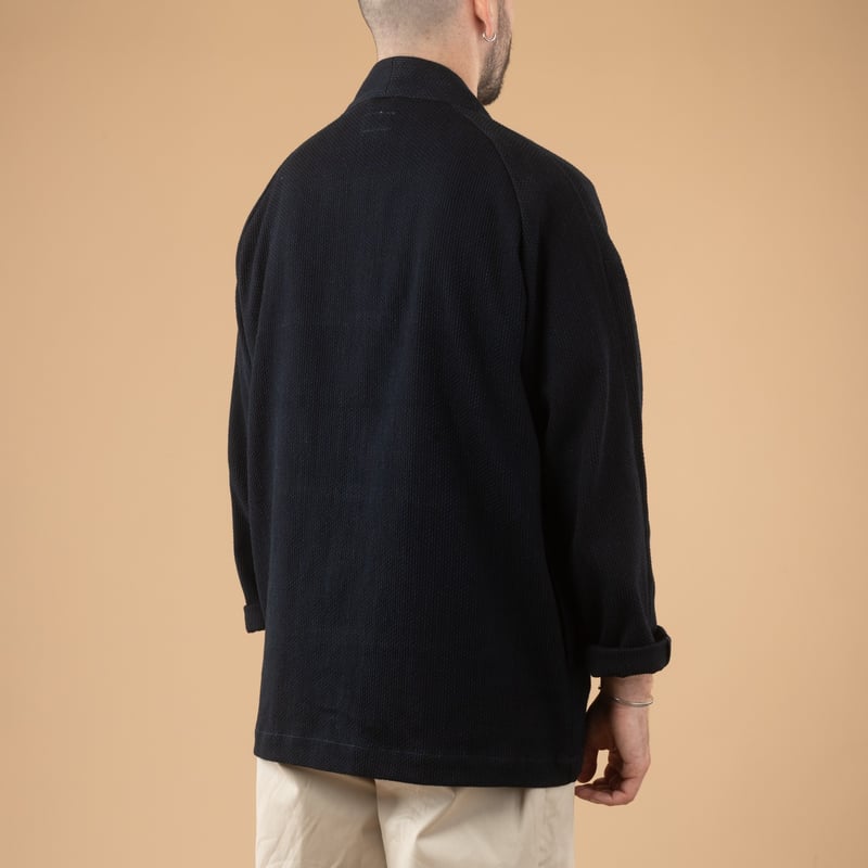 Image of flâneurs wearing a JAPAN BLUE JEANS Indigo Sashiko Haori-3 jacket on their back.